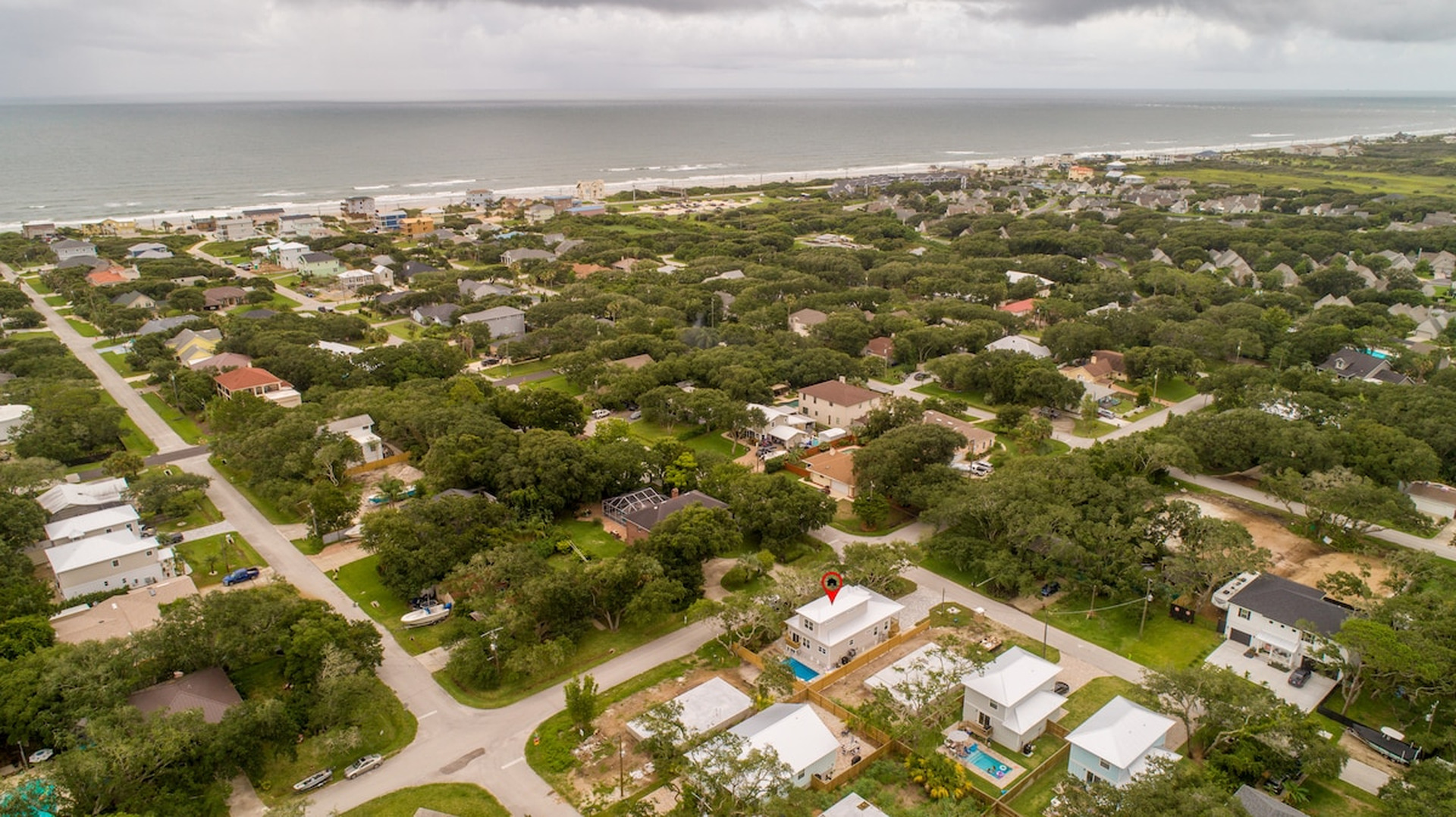 Here is the house in context, a handful of blocks back from a long, uncrowded stretch of sand. Close enough to walk in flip-flops, far enough that you sleep to crickets rather than traffic on the coast road.