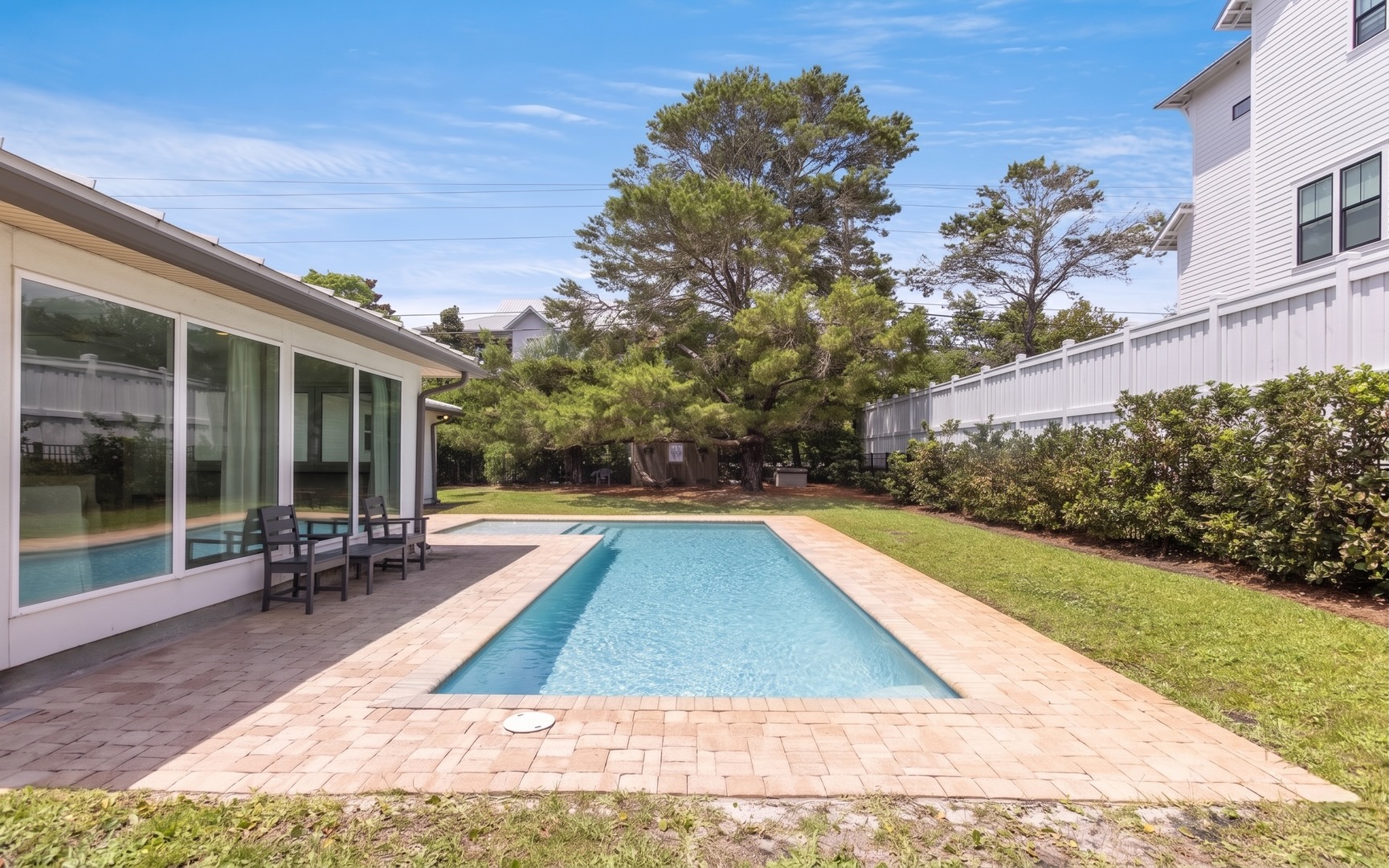 A striking stretch of blue defines the backyard, bringing understated elegance to the outdoor setting.