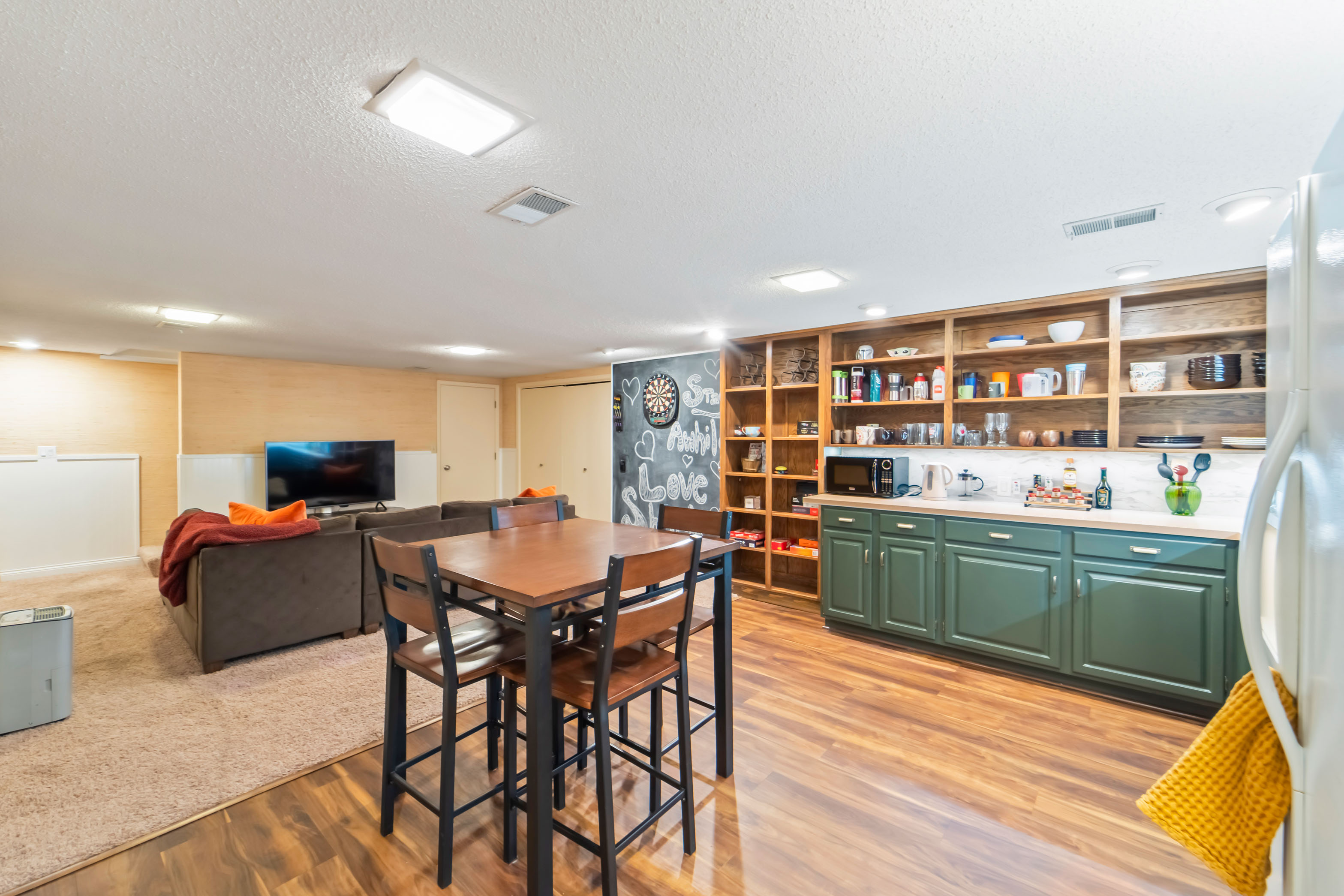 The basement kitchenette, living room, game area, and costume closet is the perfect spot for the kids to hang out and get crazy!
