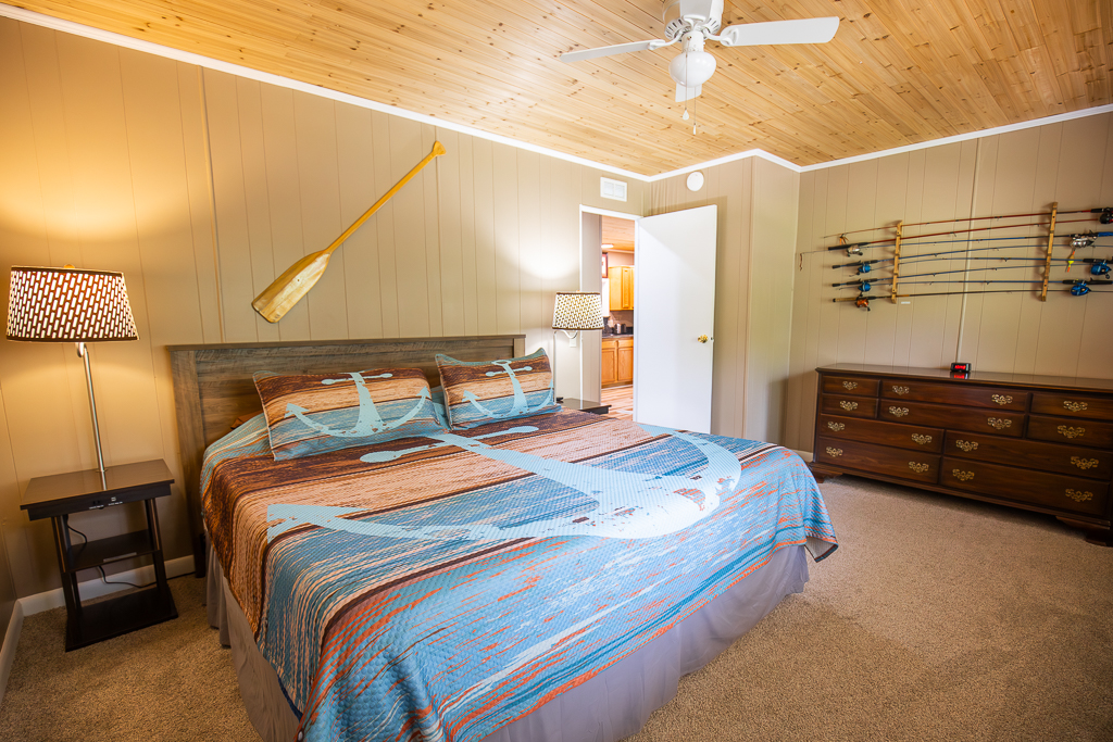 Drift off to sleep in this charming lakeside retreat, complete with soft bedding, warm wood accents, and thoughtful nautical touches.