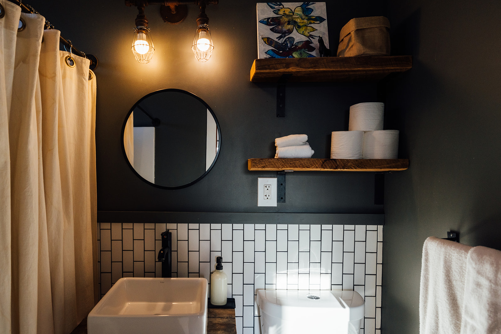 Modern bathroom with walk-in shower, elegant tile details, and warm wood accents for a boutique desert stay.