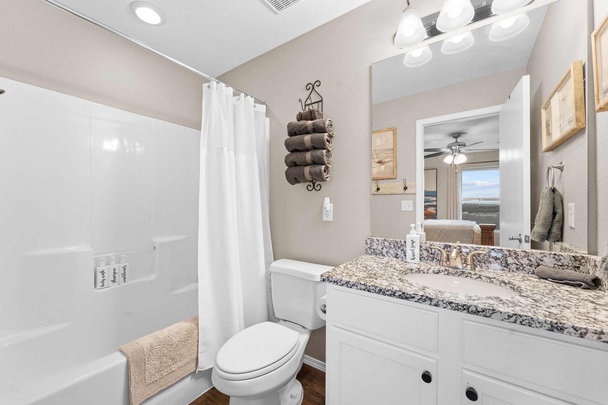 Full bathroom with shower and granite vanity