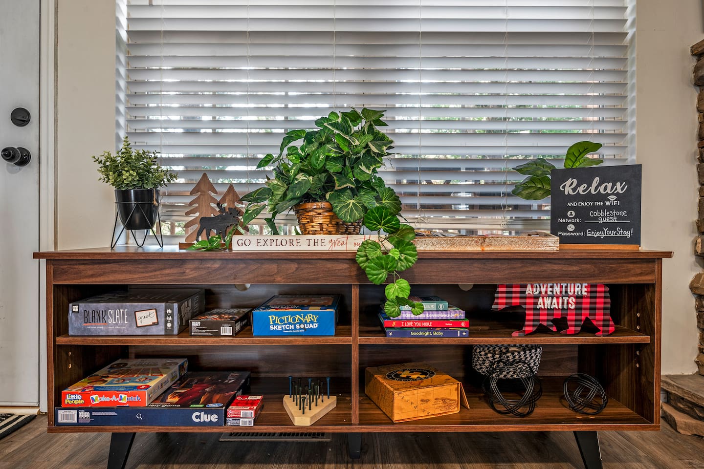 This cozy game nook invites relaxation and fun! 🌲🧩 With board games, books, and thoughtful touches like Wi-Fi info and decor that says “Adventure Awaits,” it’s the perfect space to unwind and enjoy quality time indoors.
