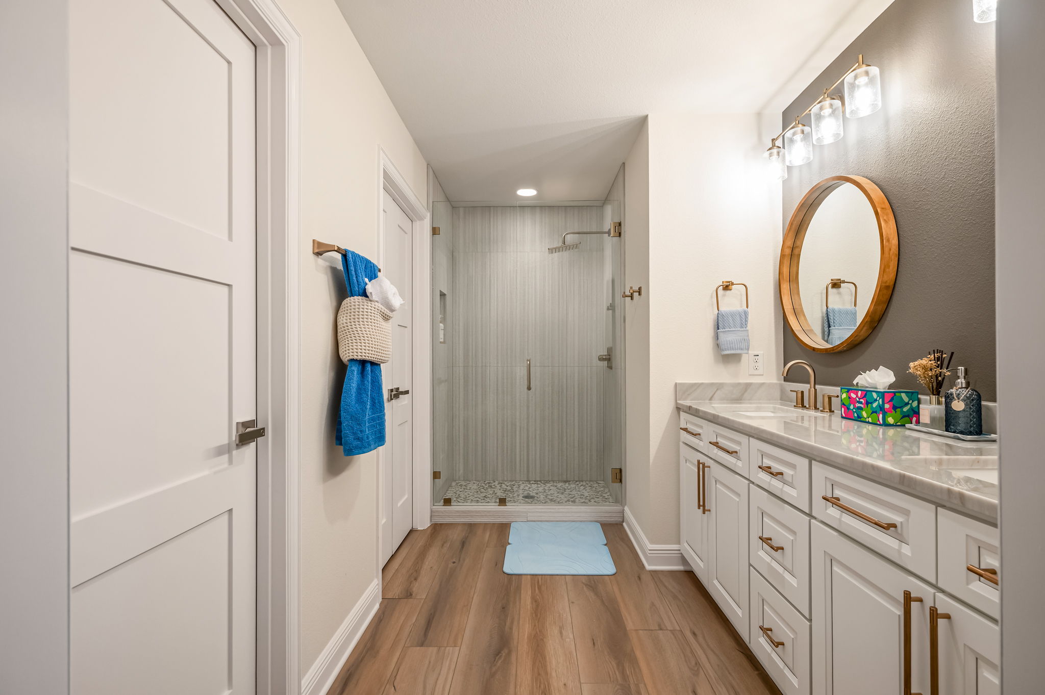 Hallway bathroom with extended vanity and walk-in shower.