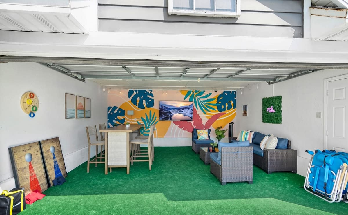 Green turf, outdoor sofas and the mural, all inside what used to be the garage. Rain or shine, this is the room the whole group gravitates back towards once the swimming is finally over for the day here.