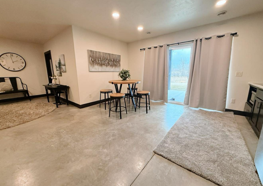 View into the dining area with privacy curtains at night.