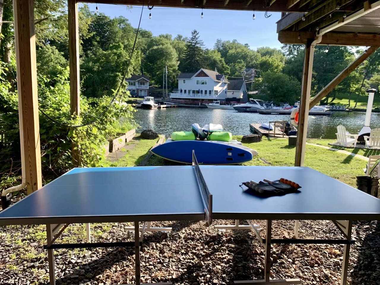 Covered outdoor ping pong with peaceful river views—perfect for family tournaments or a quick match between adventures.