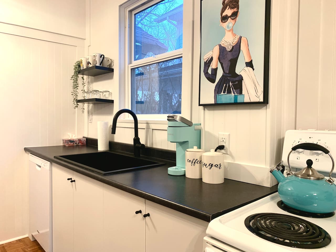 Fully equipped kitchen with stove, microwave, coffee maker, cookware, and dining essentials.