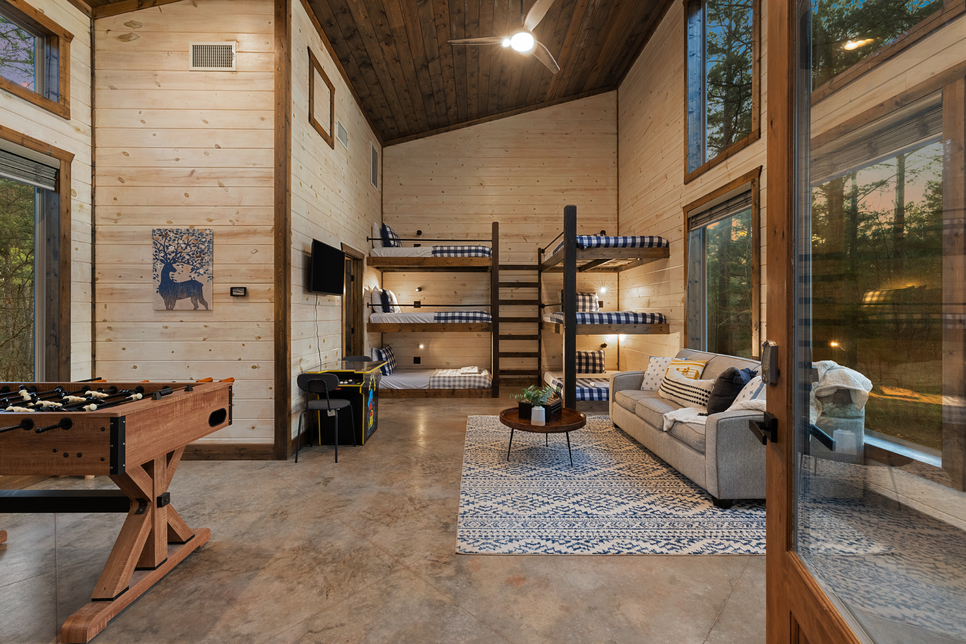 Challenge friends to foosball, spread out in the bunkhouse, and unwind with forest views and cozy cabin vibes all around.