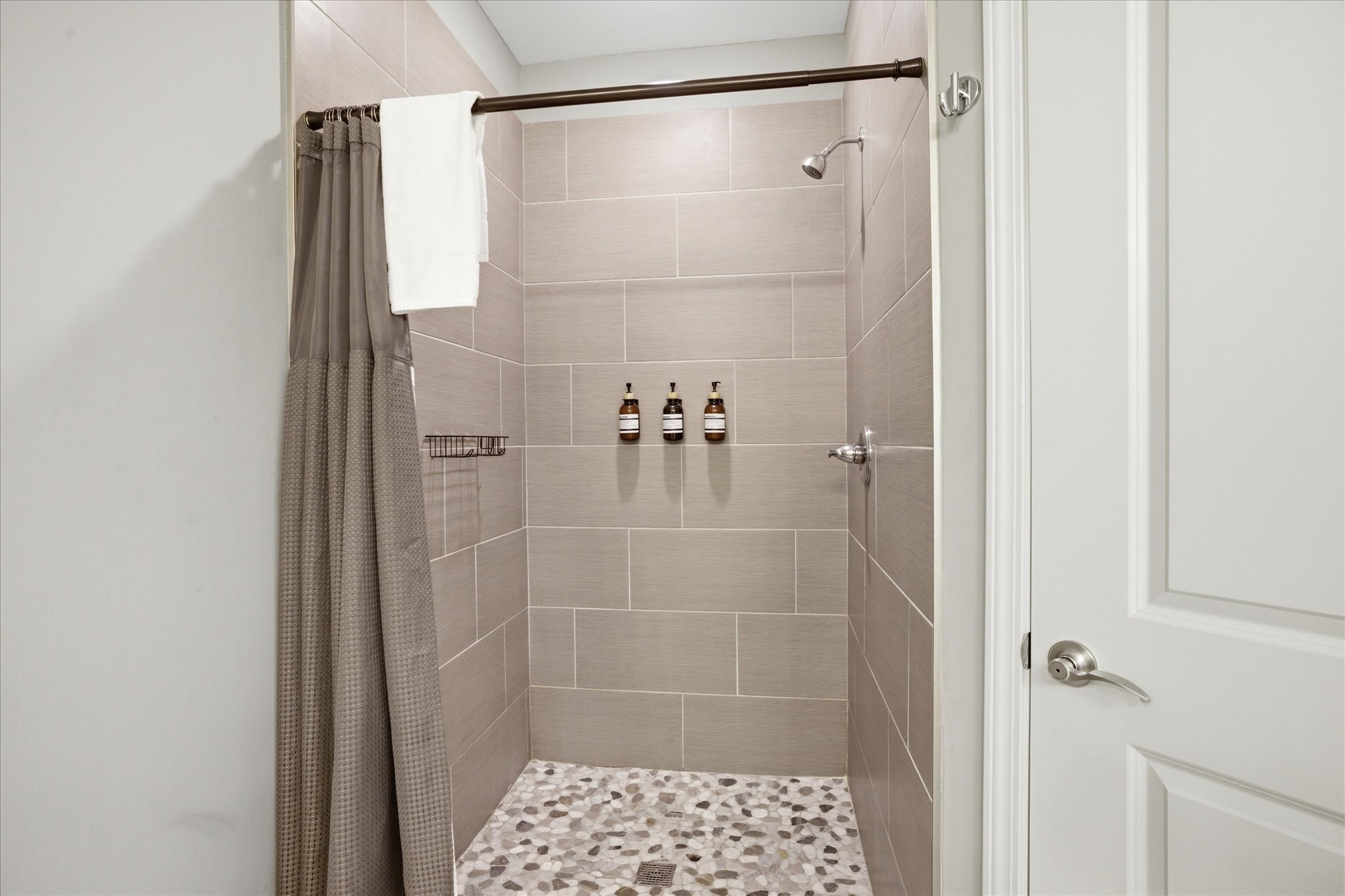 Step into Unit 1’s walk-in stone shower and take your time—spacious, simple, and set up for a full reset whenever you need it.