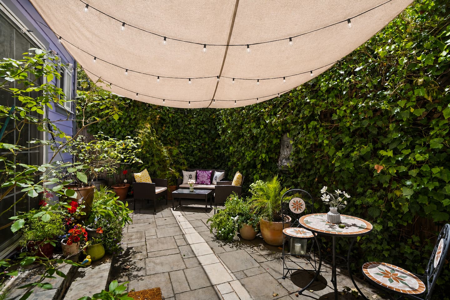 Small but cozy backyard filled with flowers — a quiet spot to unwind after wine tasting or exploring downtown Napa.