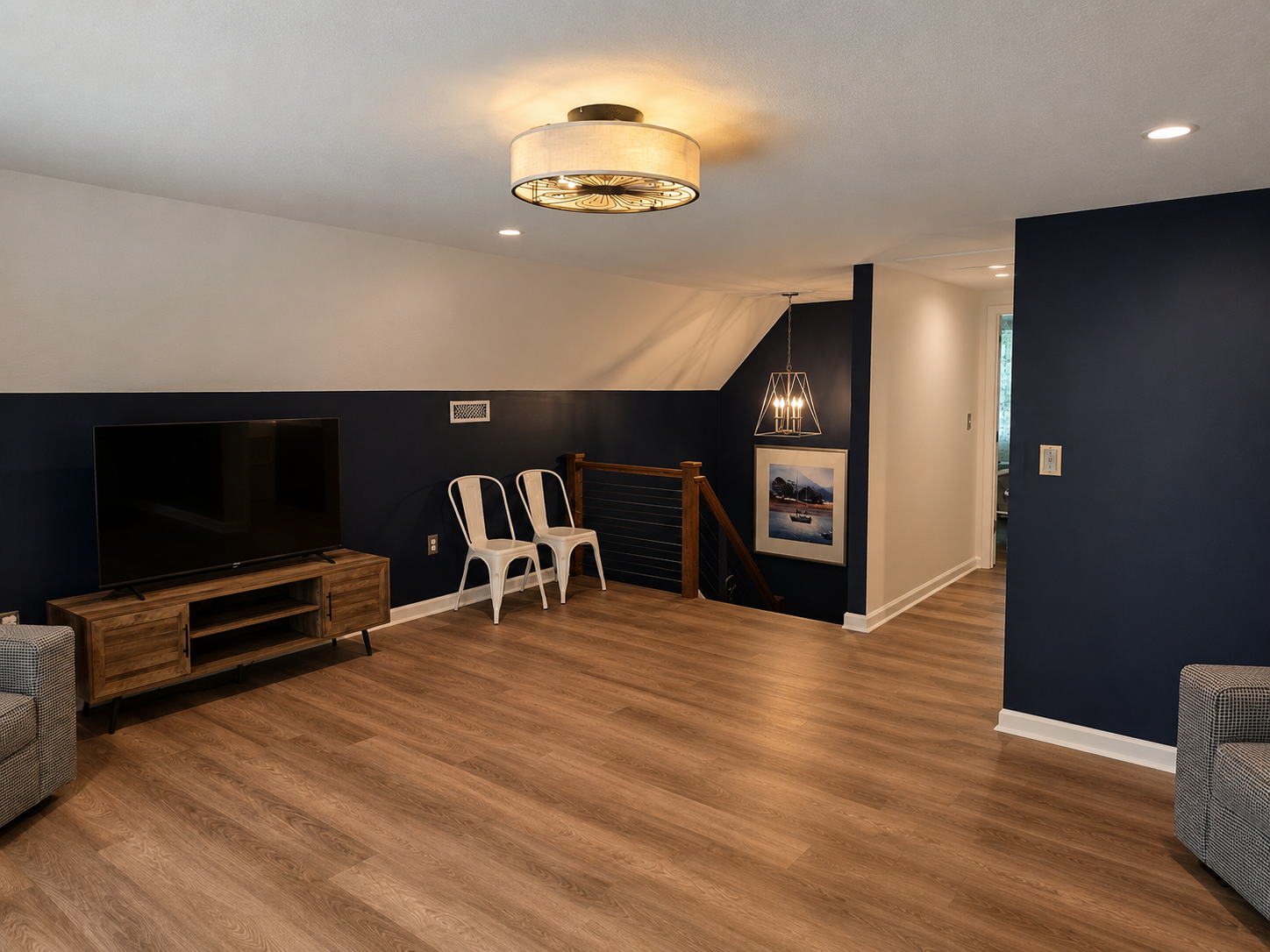 Relaxed upstairs loft with a large TV, open seating area and easy access to the upper-level bedroom, powder room and deck.