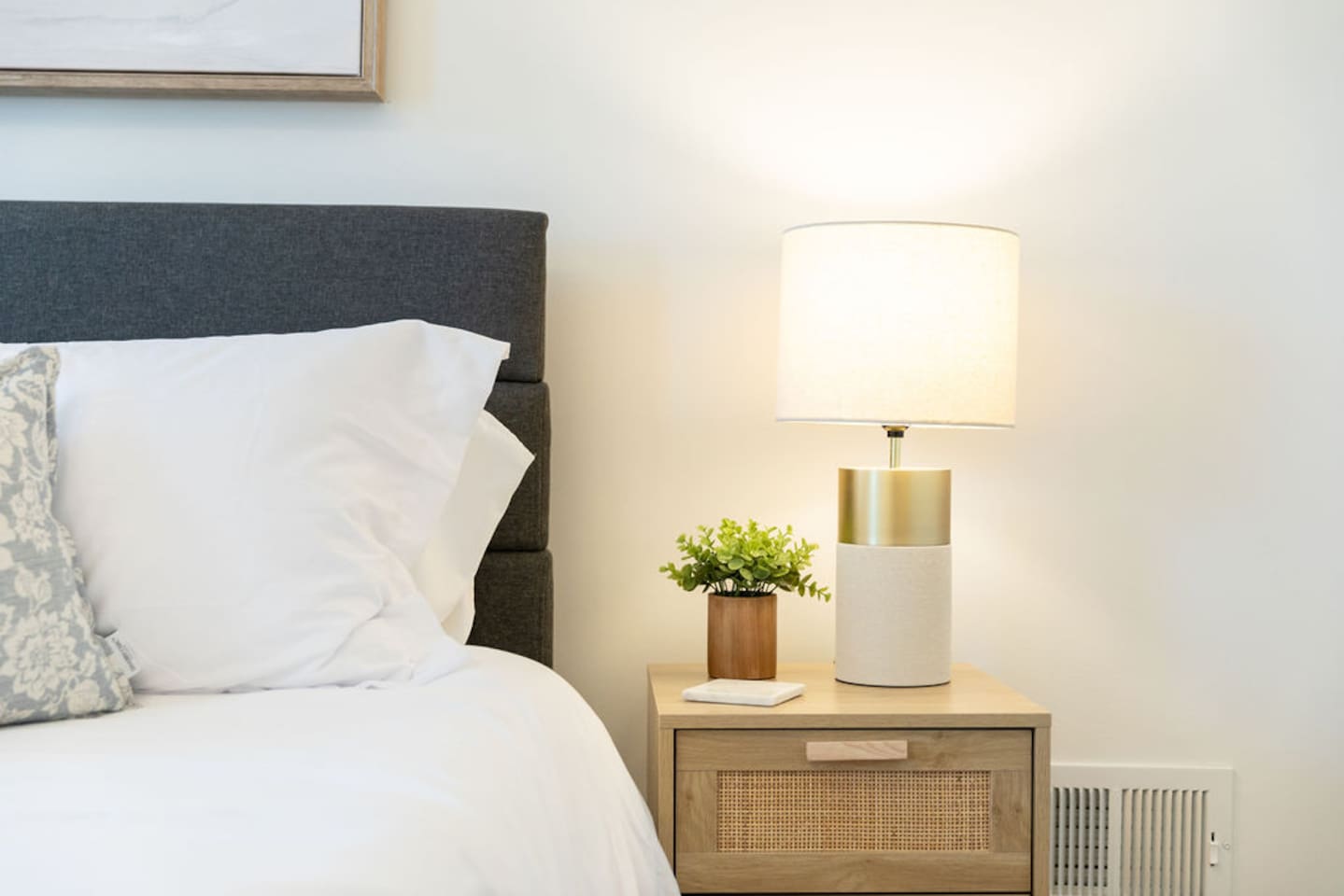 Side table with a lamp, adding both functionality and warmth to the room.