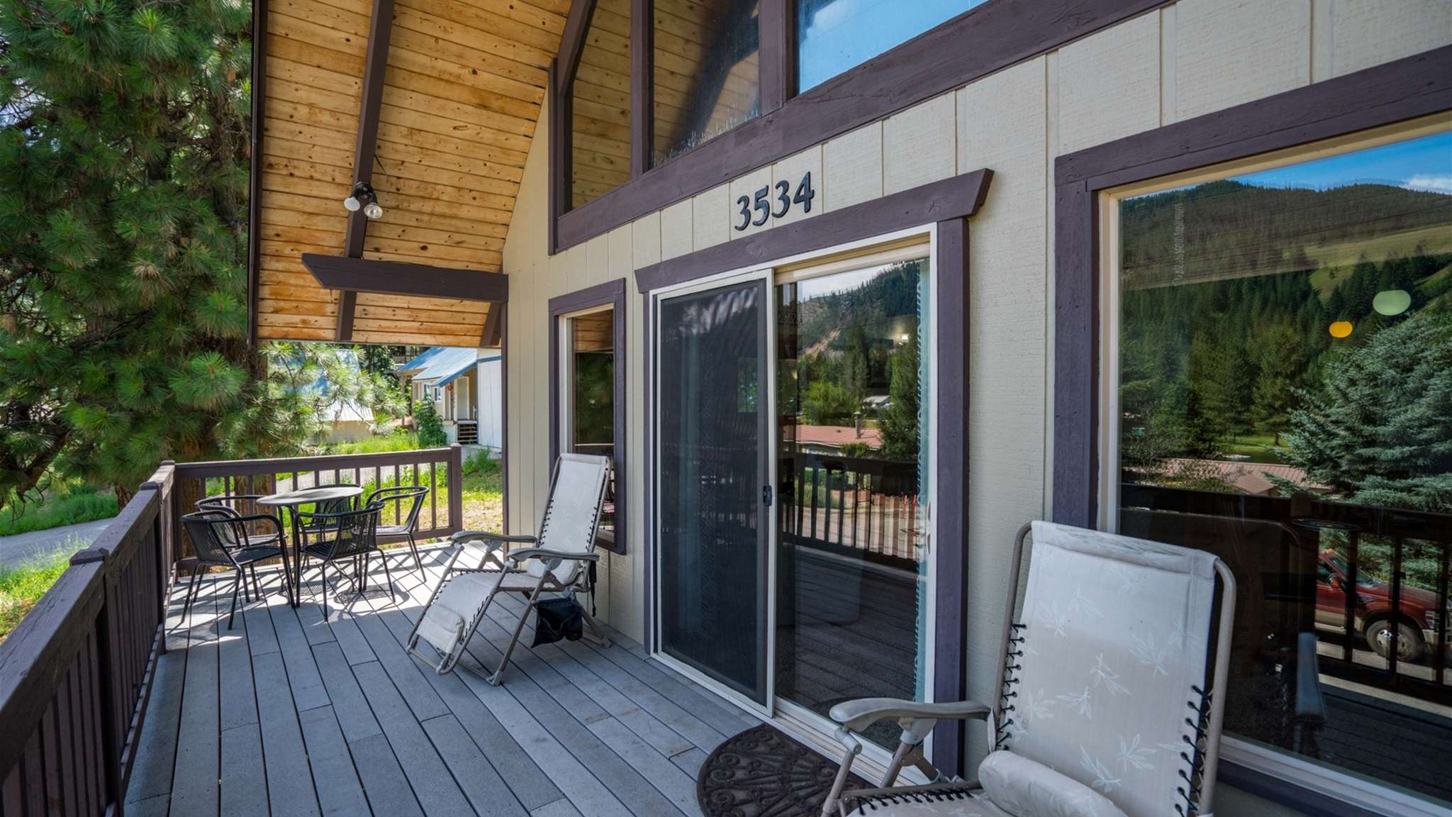 Spacious front deck with seating — perfect for morning coffee or evening wine.