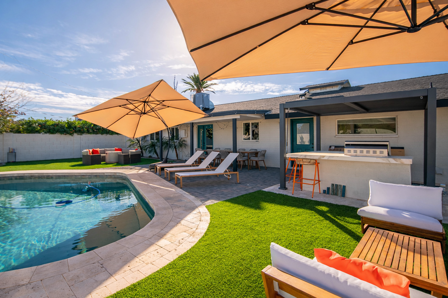 Spacious backyard featuring a private pool, outdoor seating, and bar area — designed for socializing, pool days, and evening hangouts.