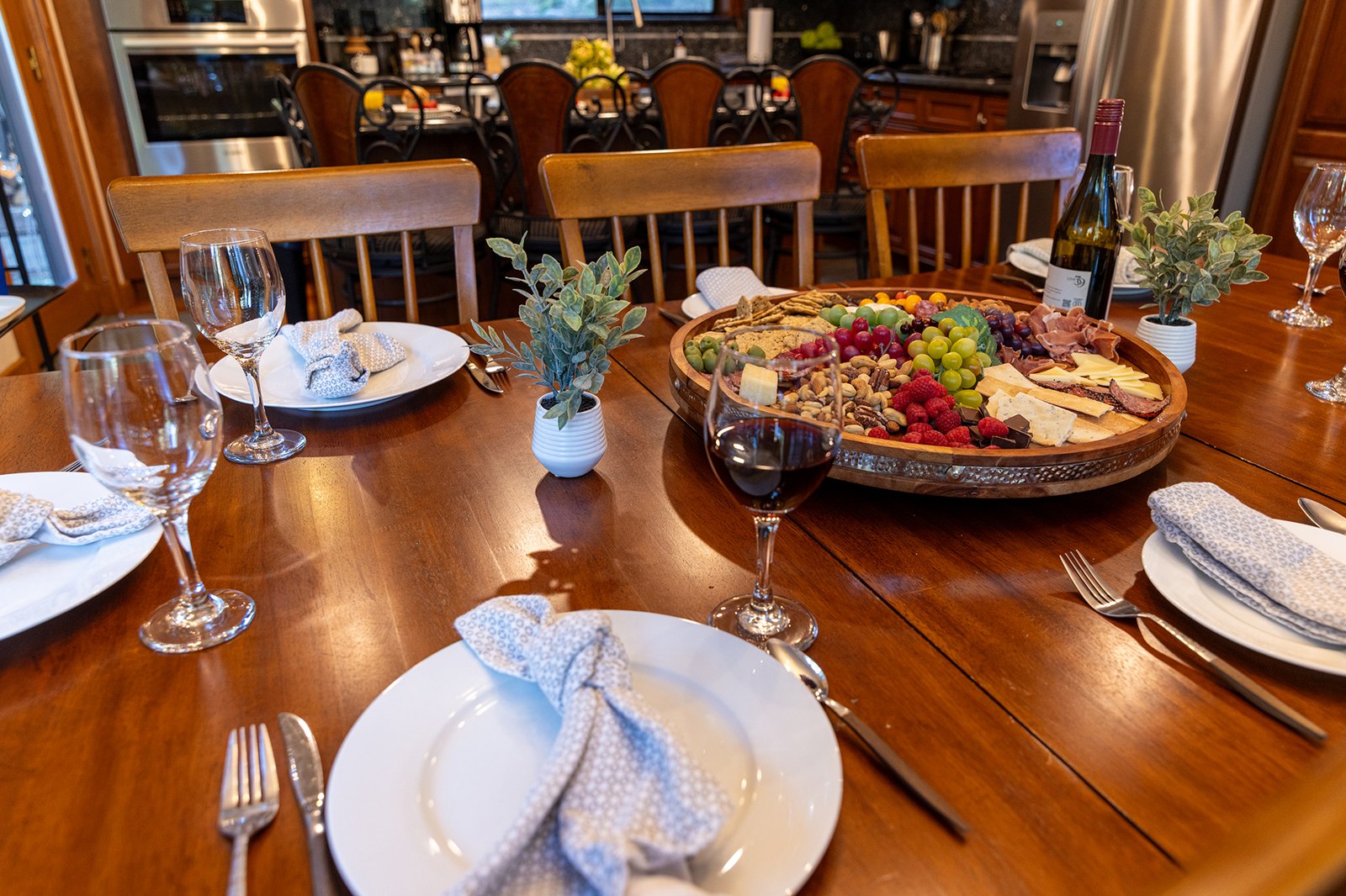 Build a grazing board and let dinner take its time — the table seats the whole family with the kitchen an arm's reach away.