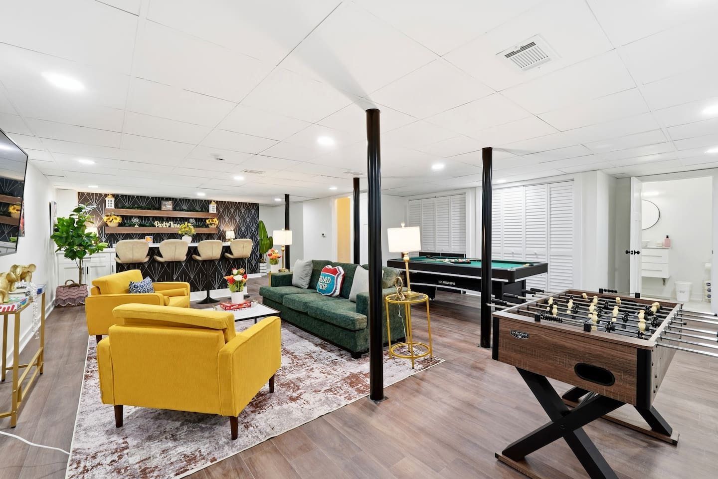 Amazing game room located in the basement, featuring a pool table, foosball table, and a stylish bar perfect for entertaining and relaxing with friends and family.