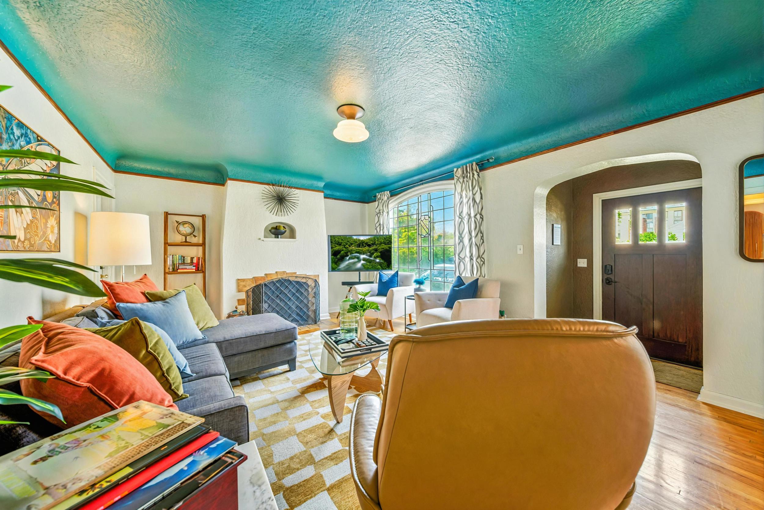 Living room with wood burning fireplace, Smart TV, record player, books & games
