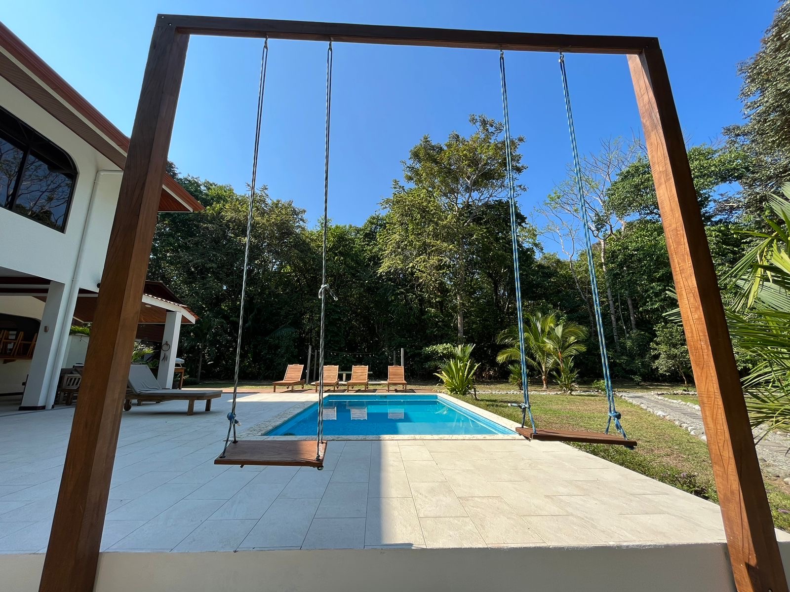 Swings overlooking the pool and patio area at Casa Sirena