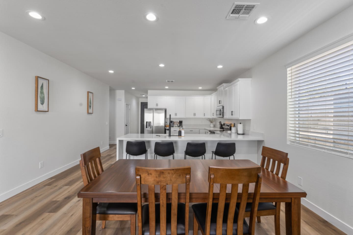 Dining area connected to the kitchen, with plenty of seating for meals or planning the day.