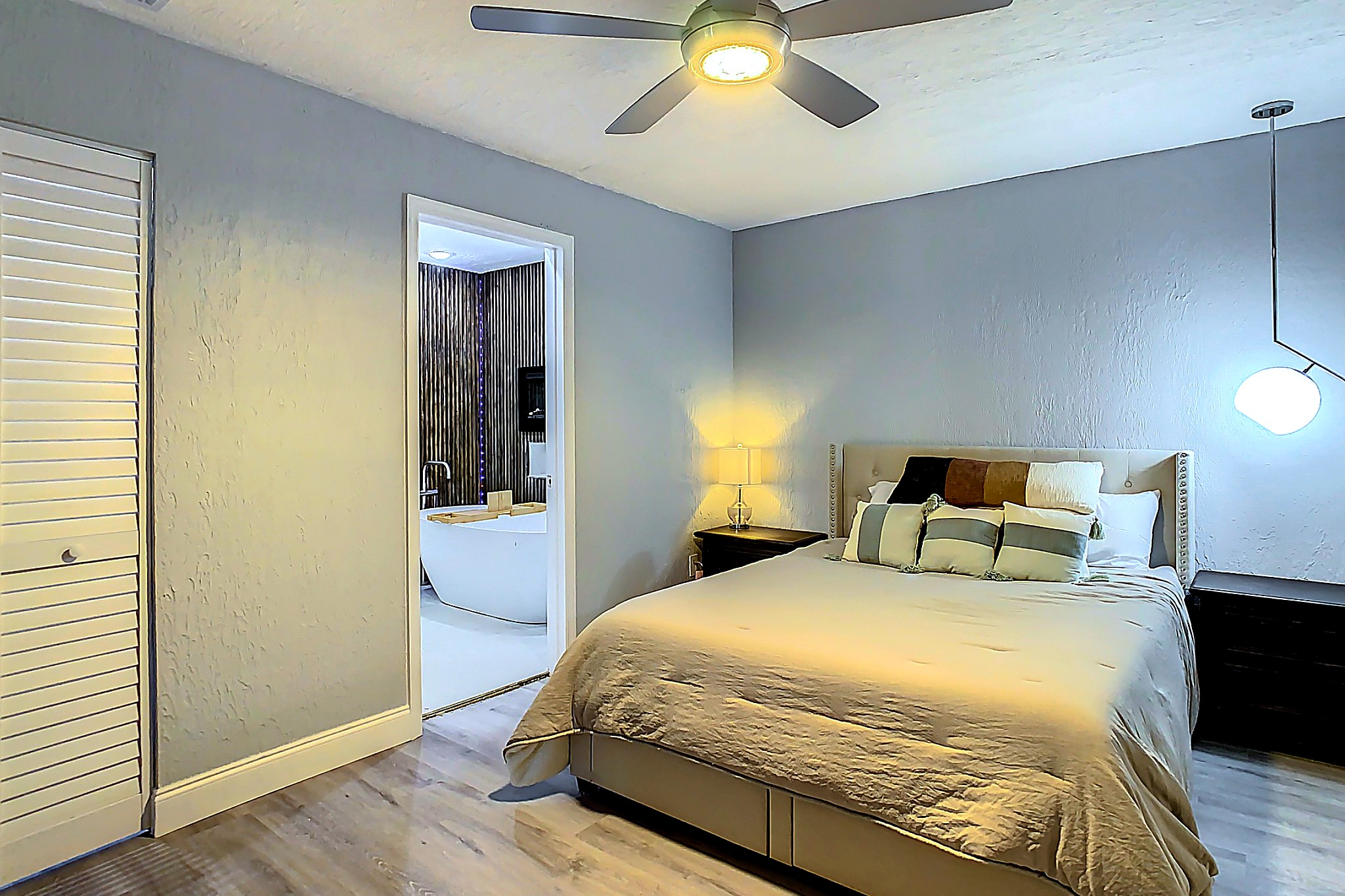 Inviting primary bedroom with comfortable queen bed, ample closet space, and peaceful ambiance for a restful stay