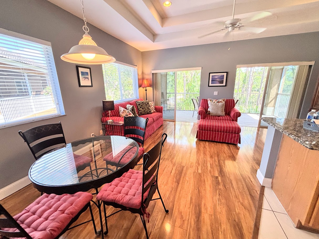 Spacious living and dining area with large windows, natural light, and an open layout perfect for relaxing or entertaining.
