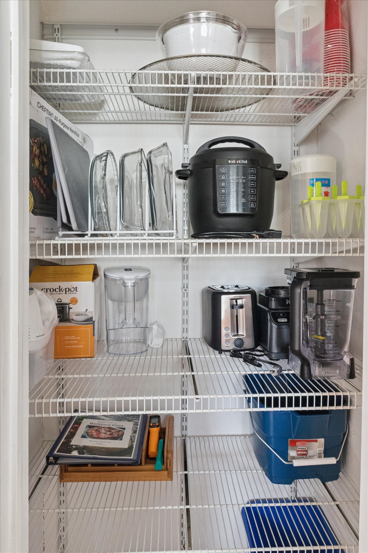 Our South Bend pantry is weekend-ready—stocked with toaster, blender, crockpot, baking dishes, Instant Pot, griddle, containers, serving platters, and pizza oven essentials.
