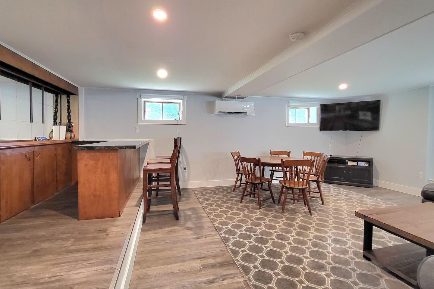 Family Room with couches, game table, and TV. Access to the fenced in back yard.