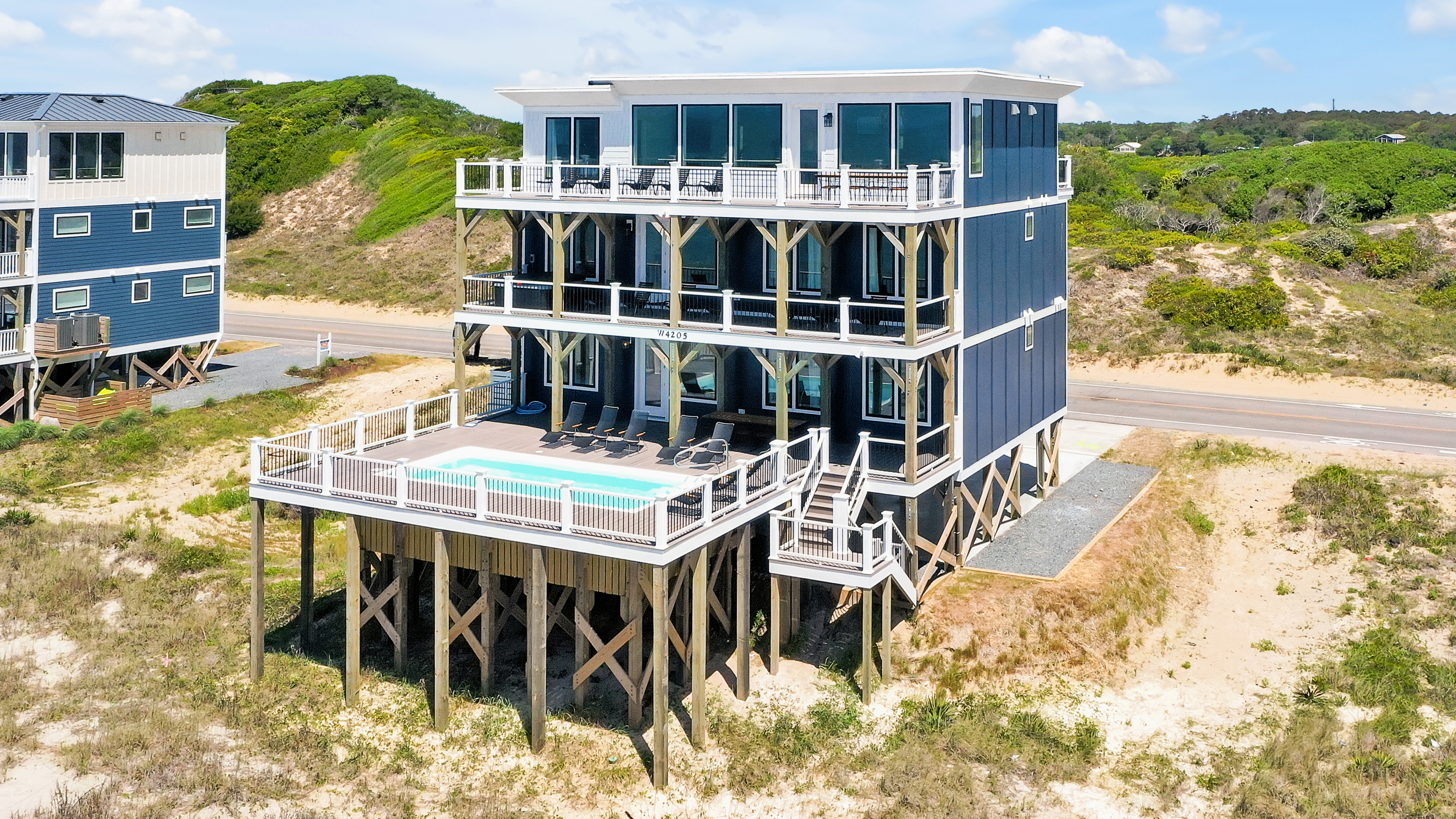 Pool on first deck, hot tub on second level, kitchen and outdoor dining on third