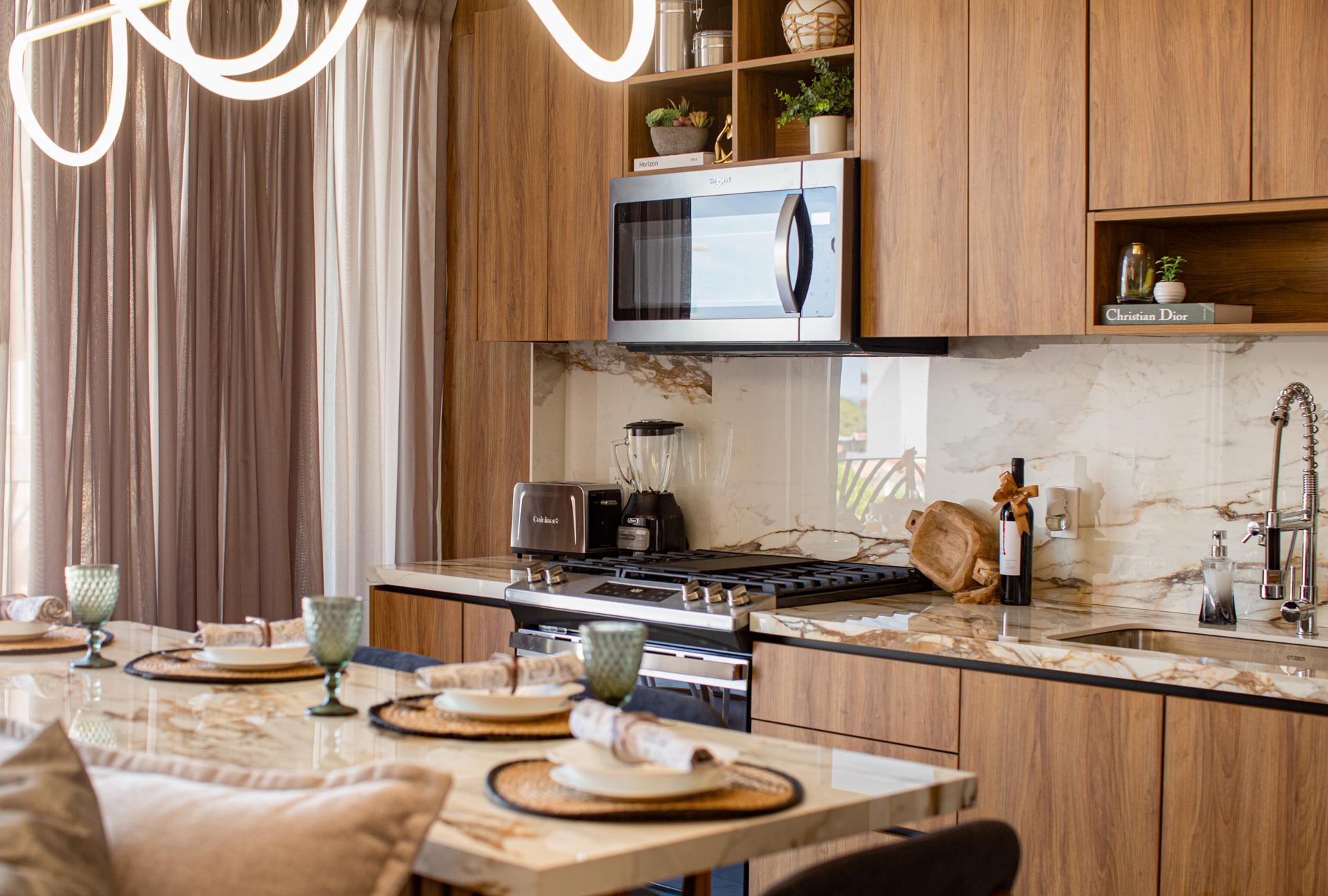 A bright, open-concept layout connects the chic living room to the modern kitchen—perfect for cooking, relaxing, and entertaining