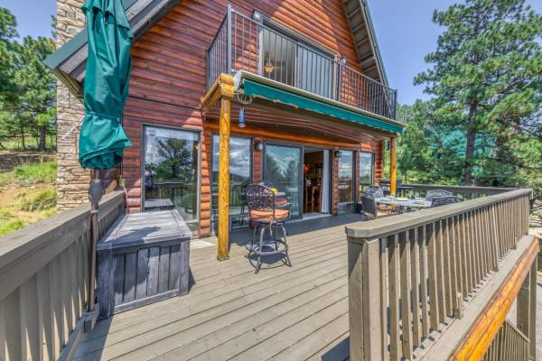 The large patio offers a perfect retreat with tables and chairs, ideal for enjoying stunning nature views and the peaceful outdoors