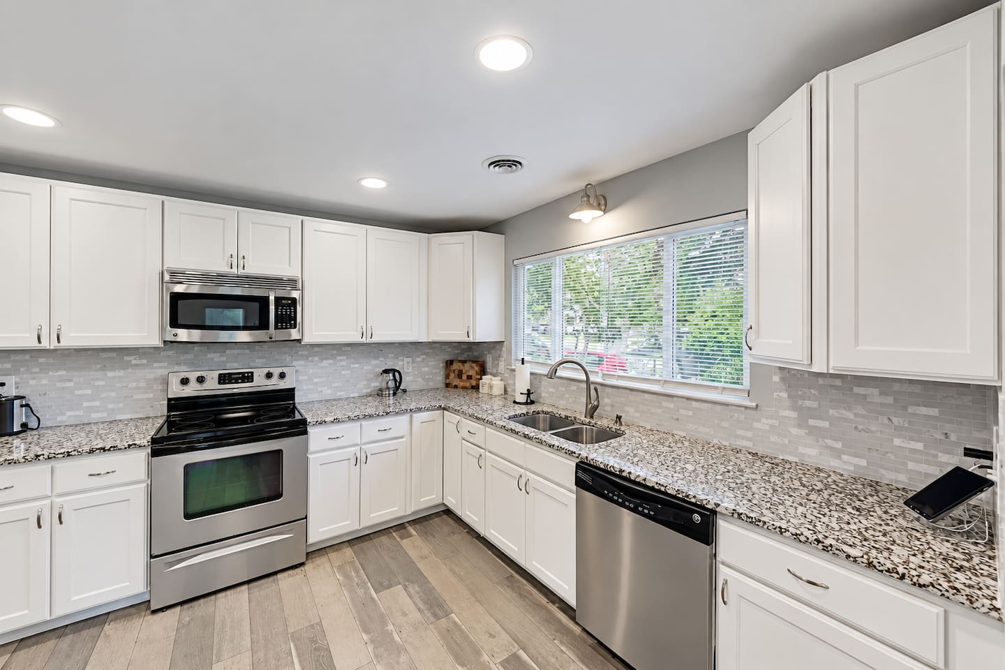 Kitchen: Bright and sleek space with granite counters, modern appliances, and plenty of natural light!