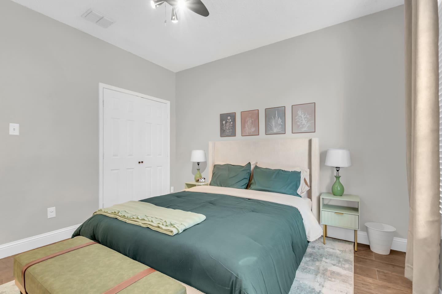 Comfortable guest bedroom offering a queen bed, room-darkening blinds, ceiling fan, fresh linens, and a guest-ready layout for family or group stays.