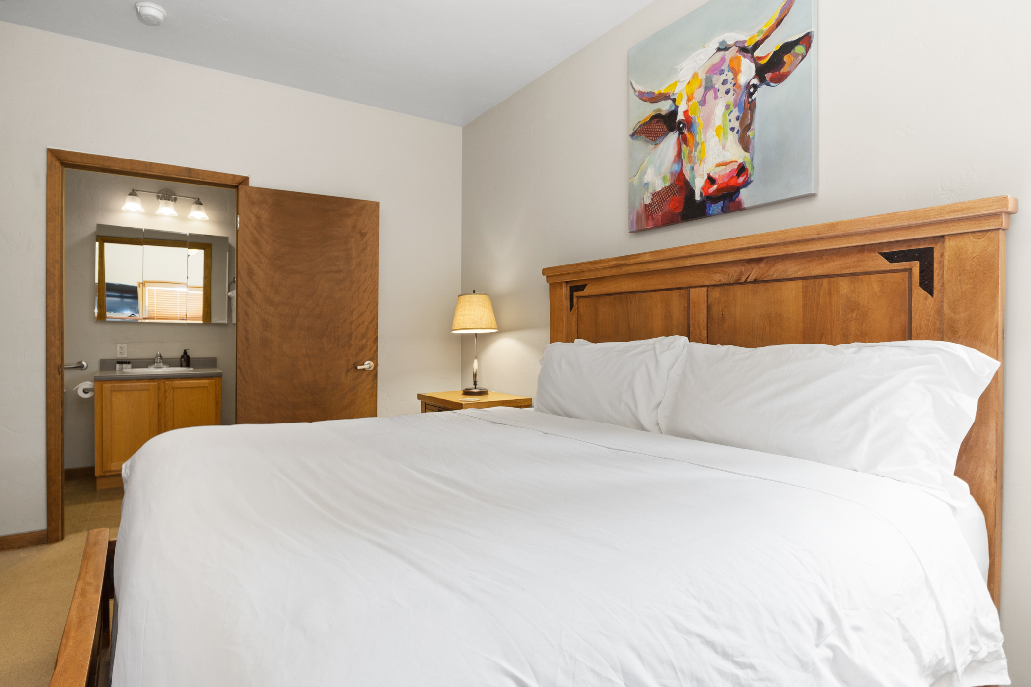 Ensuite King Bedroom 1 with Bathroom in background