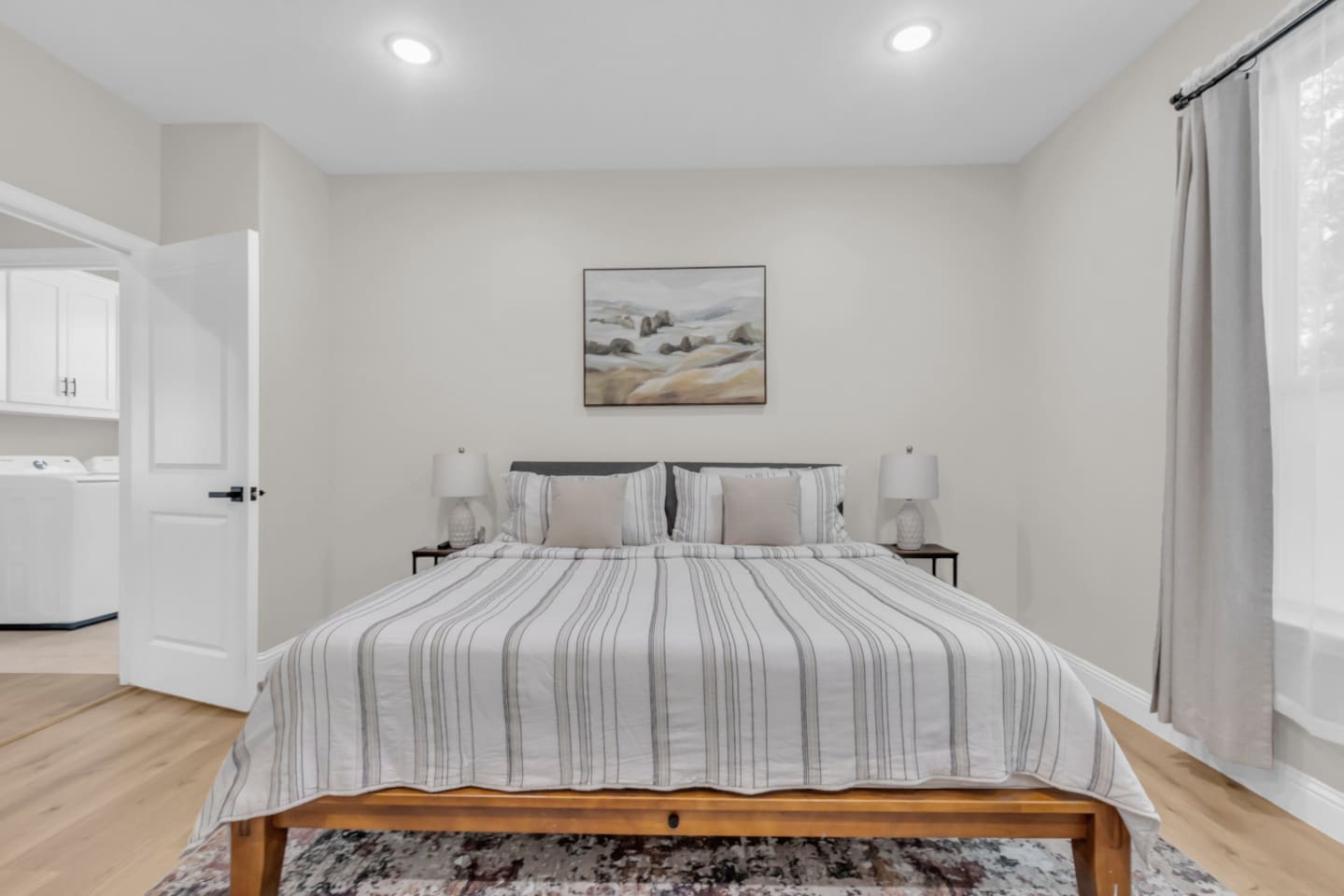 Master suite with neutral tones and stylish framed art.
