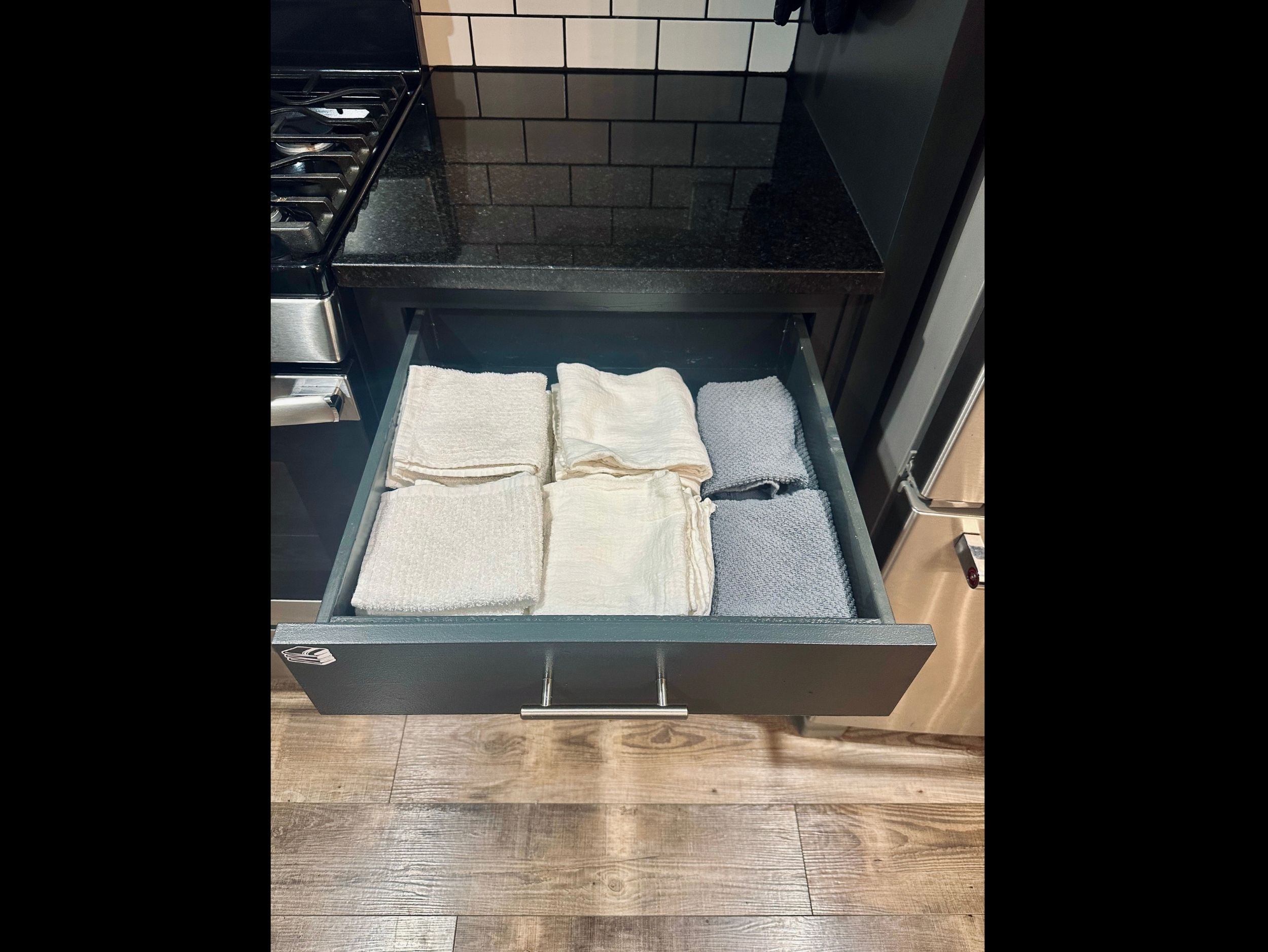 Kitchen drawer stocked with dish drying towels and hand towels to keep the space tidy and functional.