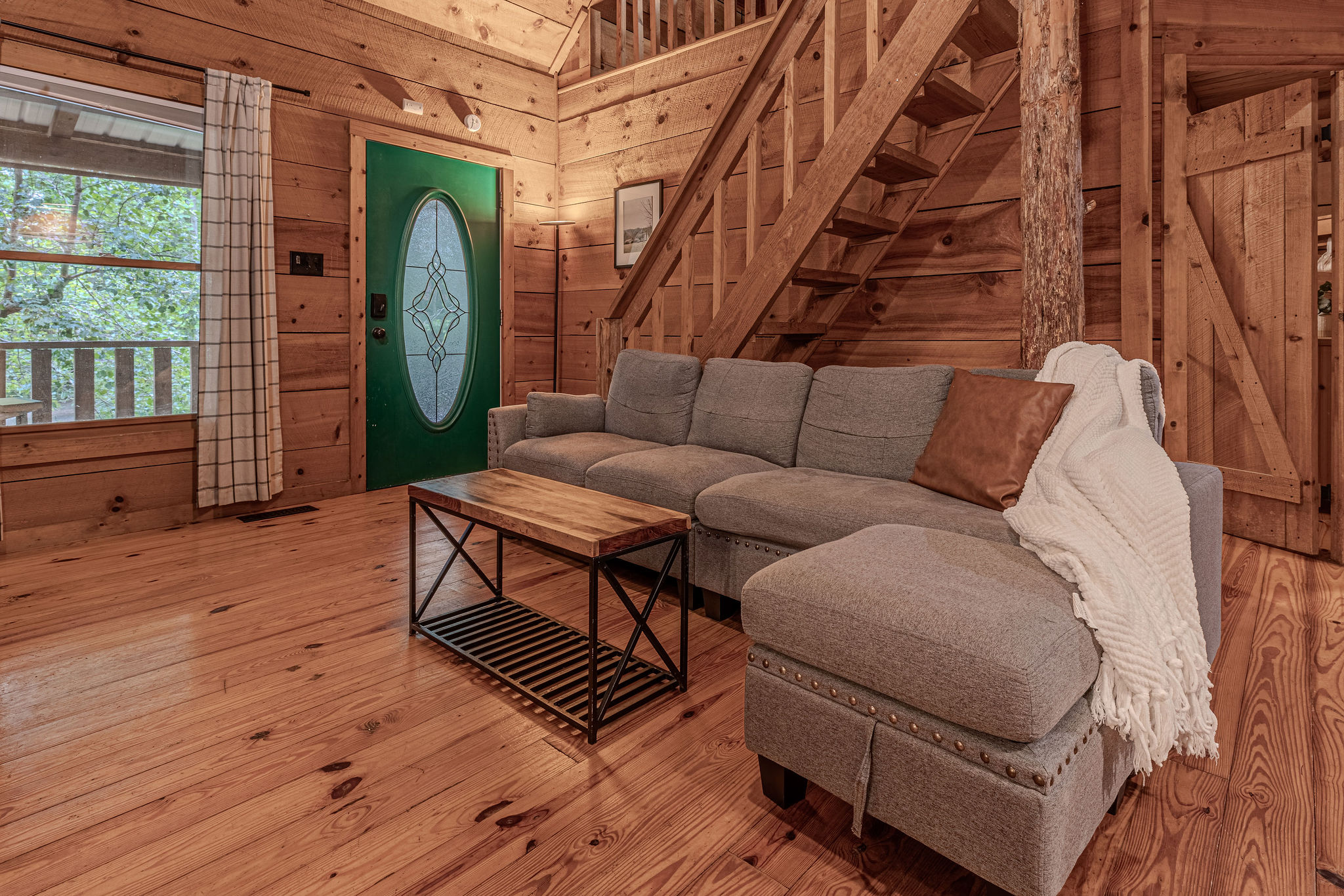 Sectional, throw blanket, green door. Come on in.