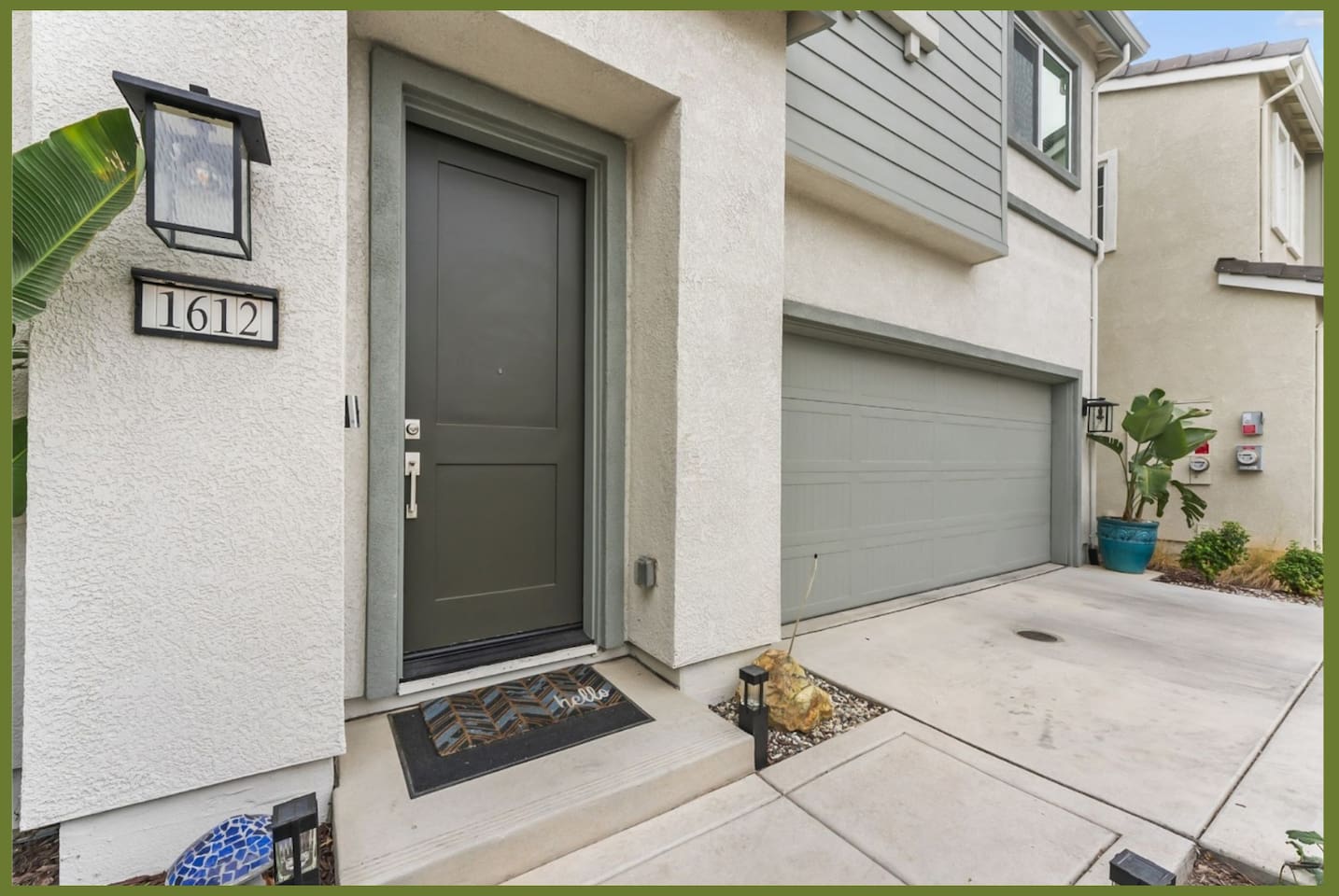 Front entry with garage access, covered doorway, and a clean driveway for easy arrivals.