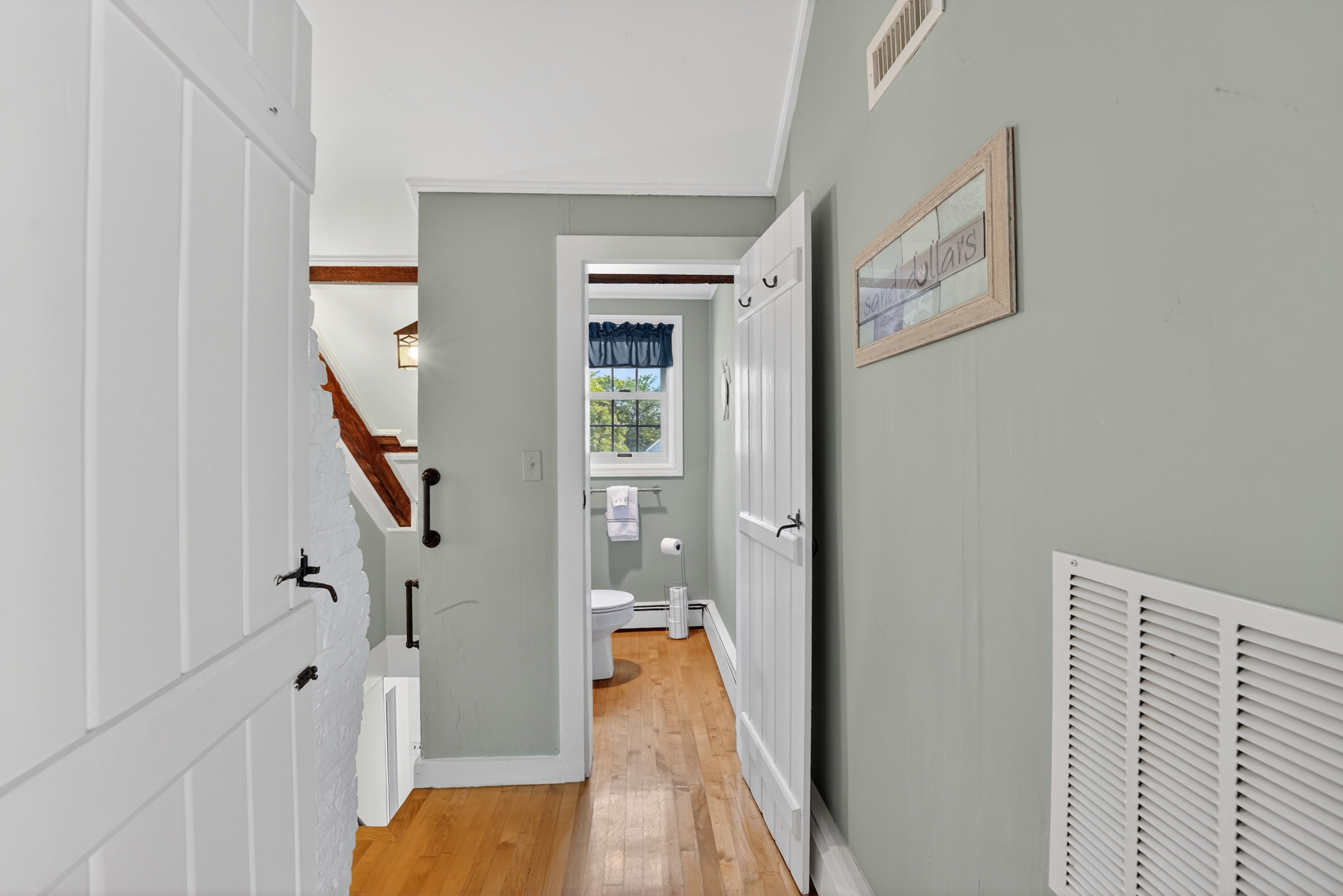 Bright upstairs hallway providing easy access to the loft, bedrooms, and full bathroom.