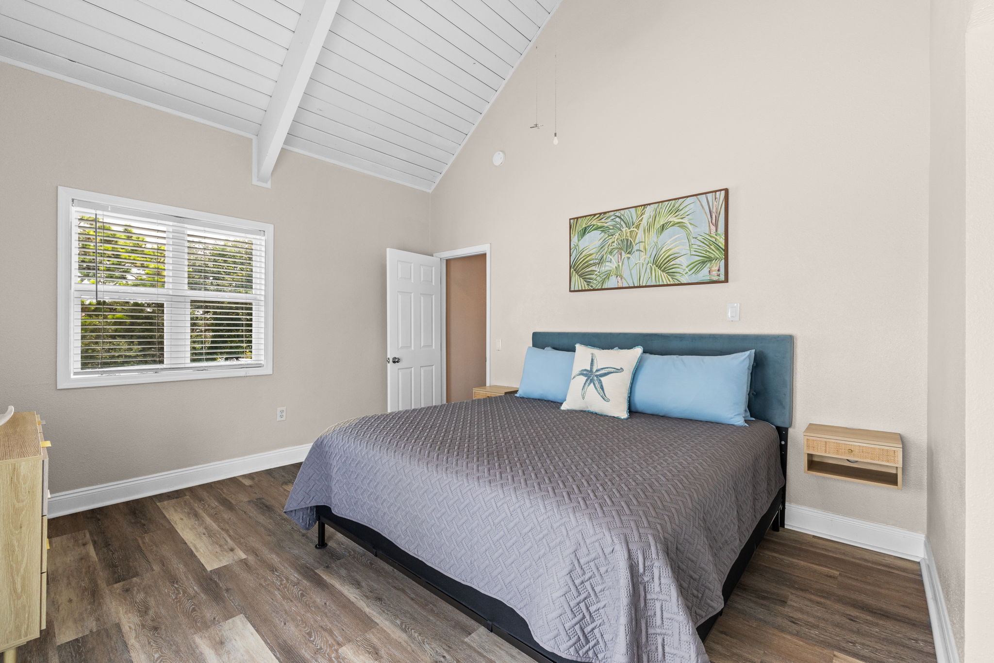 The primary bedroom has a king size bed.