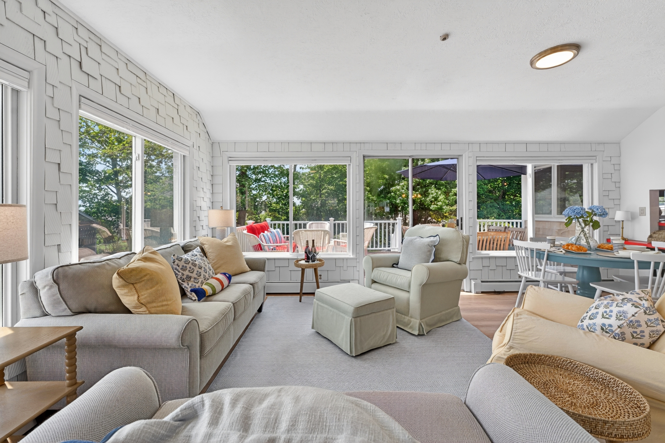 Stylish living room filled with soft daylight, offering a spacious and comfy setup ideal for both relaxation and casual entertainment.