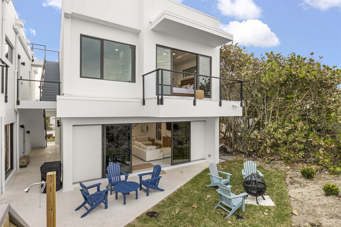Experience the elegance of this outdoor space with stylish tables and chairs, exquisite flooring, and a glass side door leading indoors. The terrace offers stunning views, with a window and sliding door from the second floor adding to the charm.