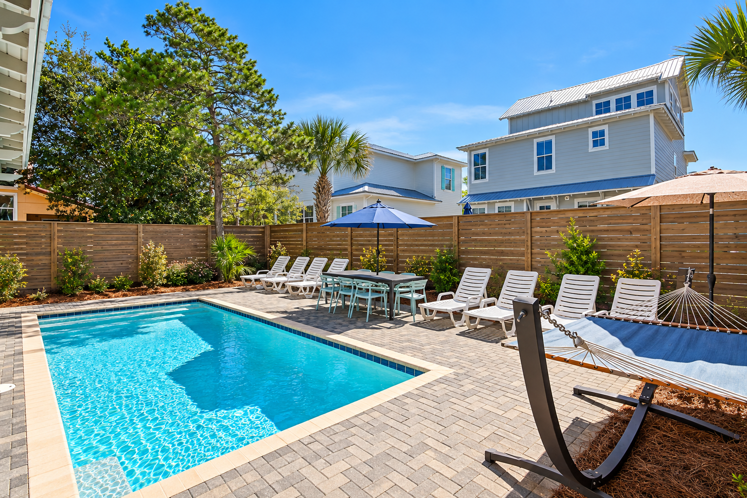 The private pool area features lounges, poolside tables and chairs, a hammock, and a grill.