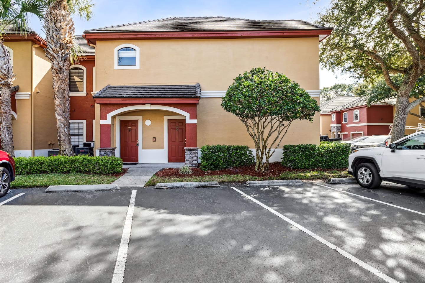 Entrance to unit, Door on the right. Parking spot is Middle spot (right of sidewalk)