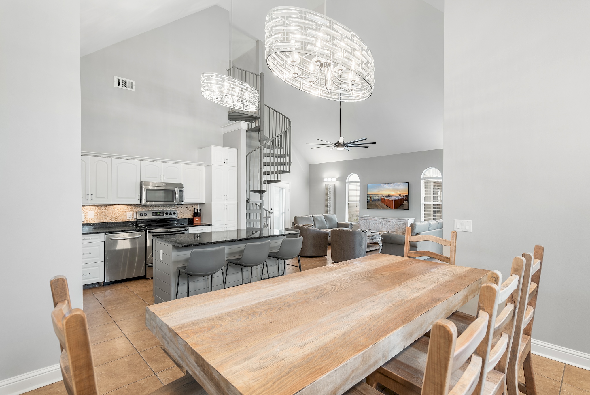 Dining area with seating for eight beneath a statement chandelier