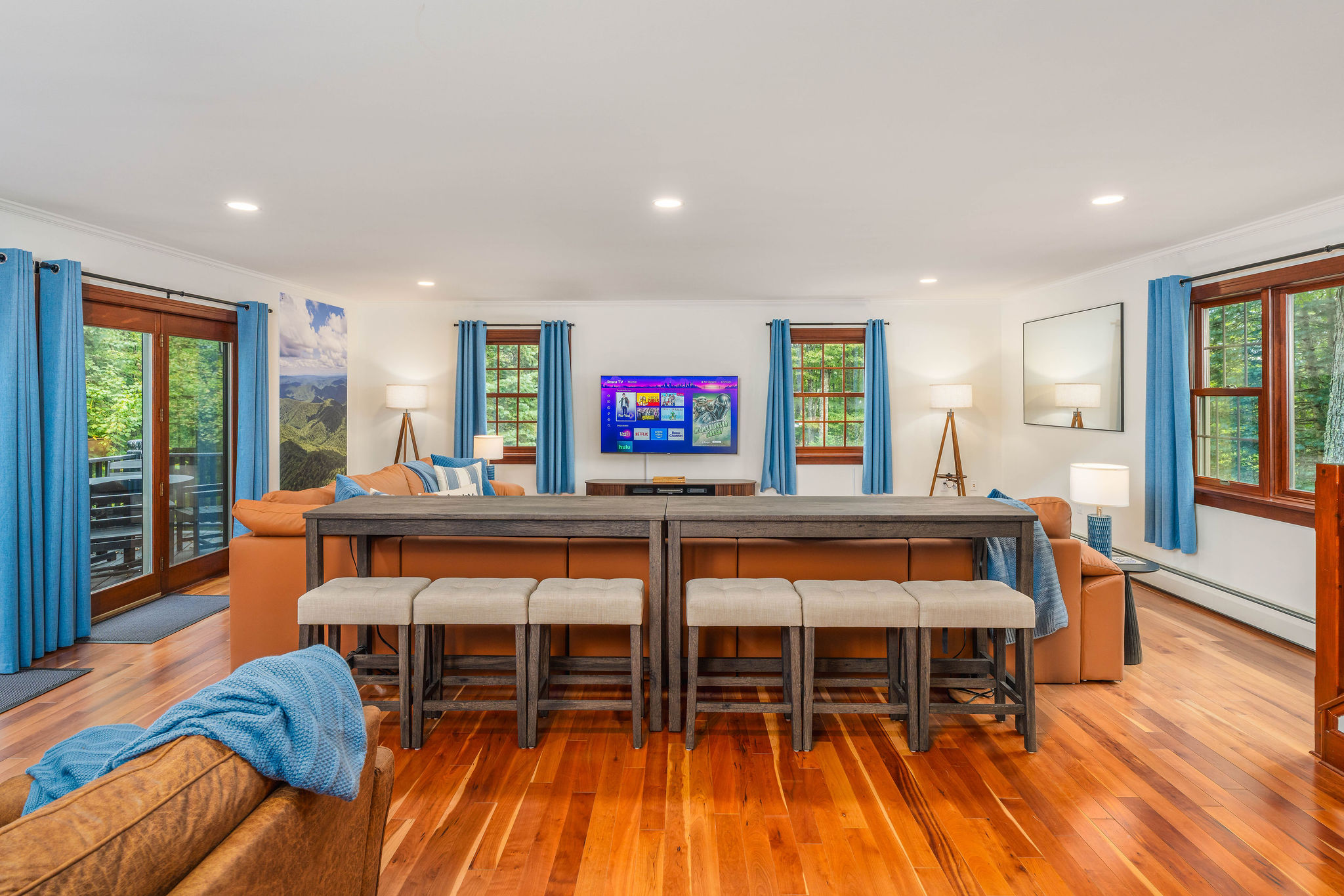 📺 Sectional seating for 6 plus bar-back seating for 6 more, all facing the 65" HDTV — everyone gets a seat for movie night.