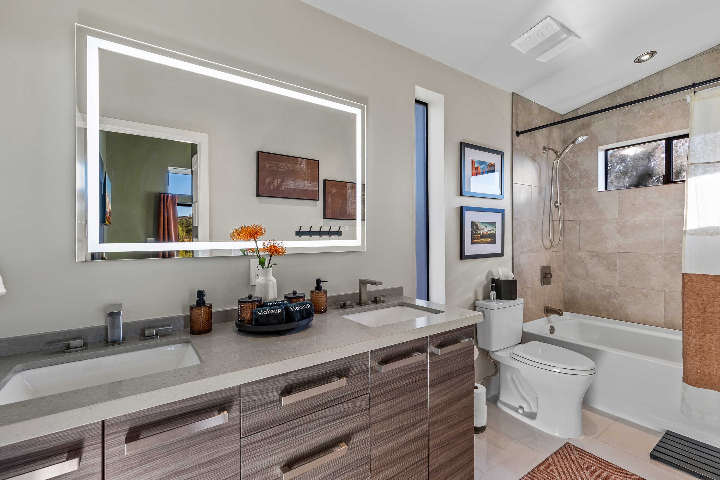 A spacious bathroom with a large vanity, ample counter space, and a tub-shower combination - designed for comfortable, stress-free mornings. 