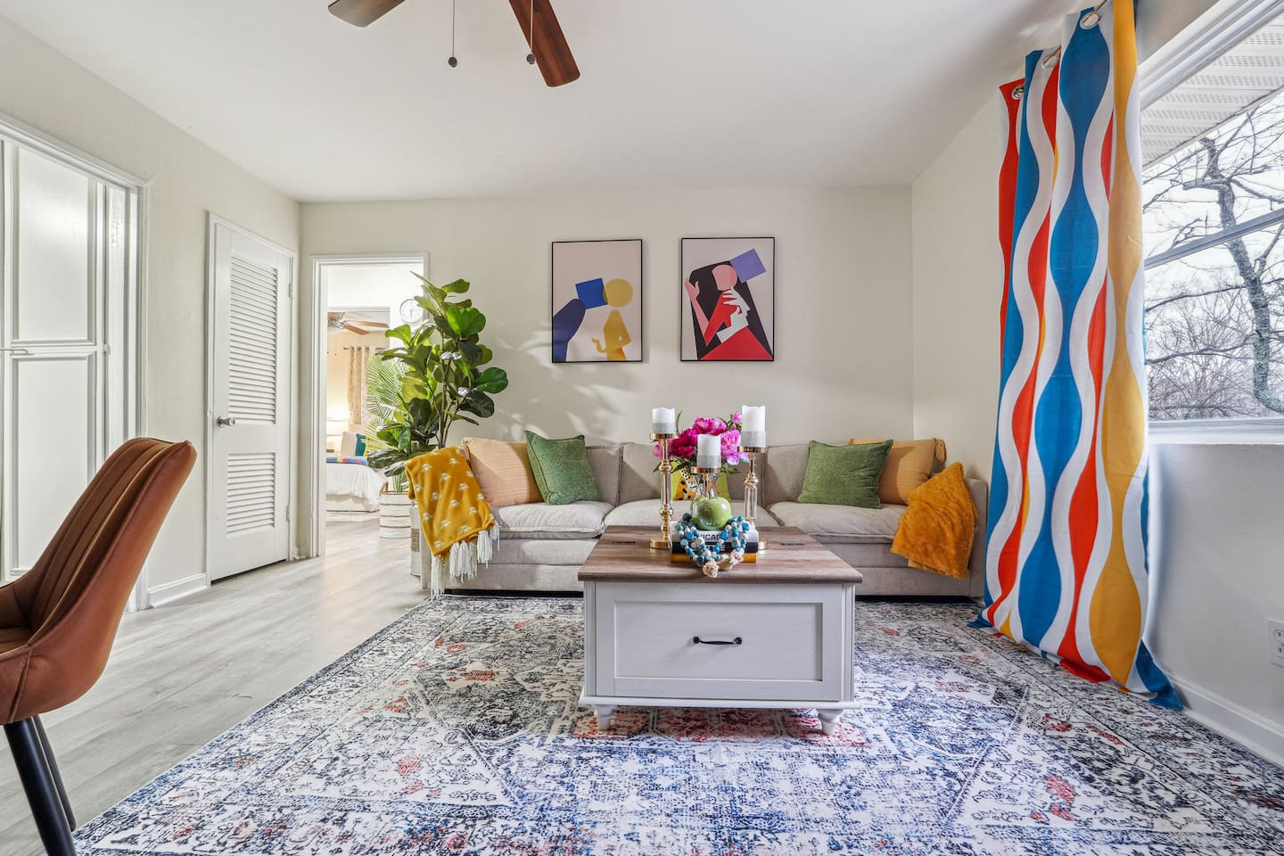 Enjoy a cozy living room featuring a comfortable couches, a TV for your entertainment, and a window with a lovely view outside, perfect for relaxing and unwinding.

