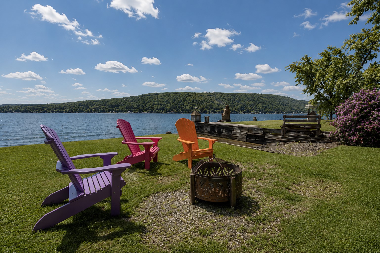 Gather around the fire with colorful Adirondack chairs and a covered seating area 🔥🪑🎨