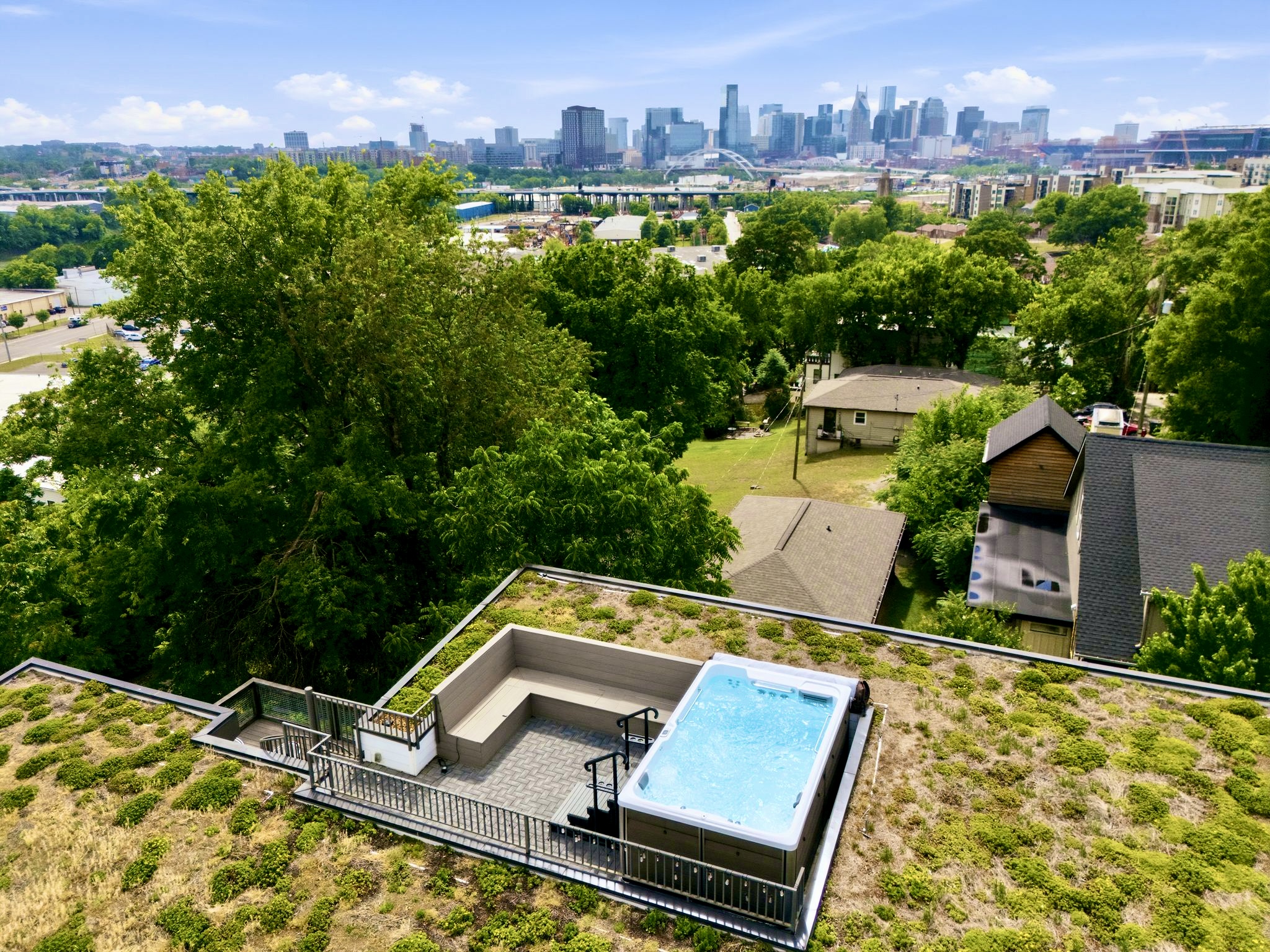 Rooftop hot tub w/ sweeping city skyline views — soak under the stars w/ the whole crew.
